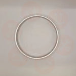 Silver ring on a light gray background